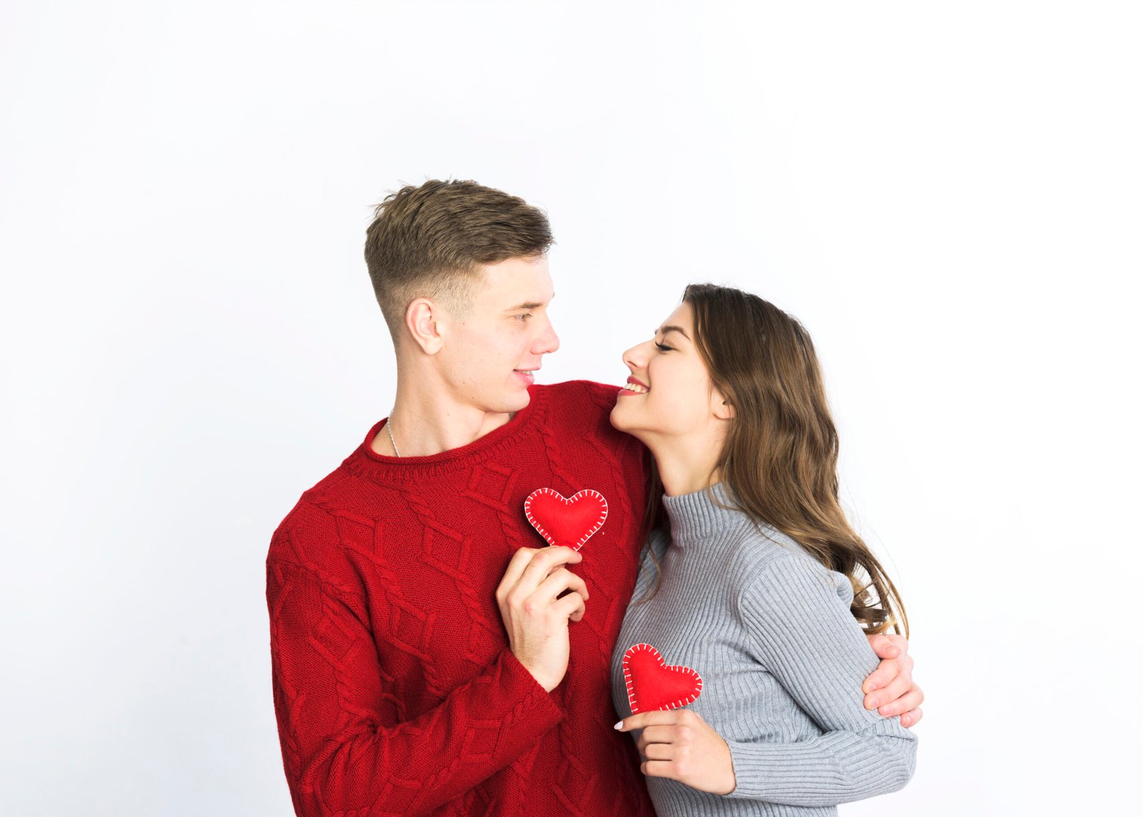 young-couple-holding-small-red-hearts-hands